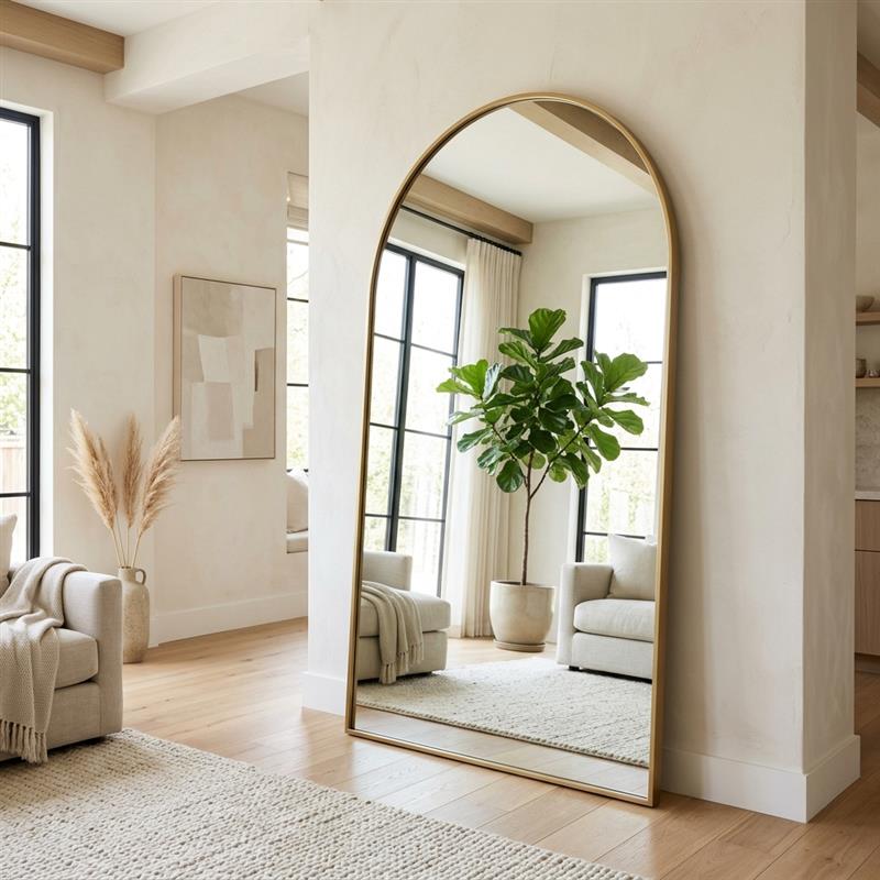 Elegantly arched floor mirror in a bright room